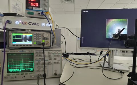Student testing with oscilloscope in laboratory setting