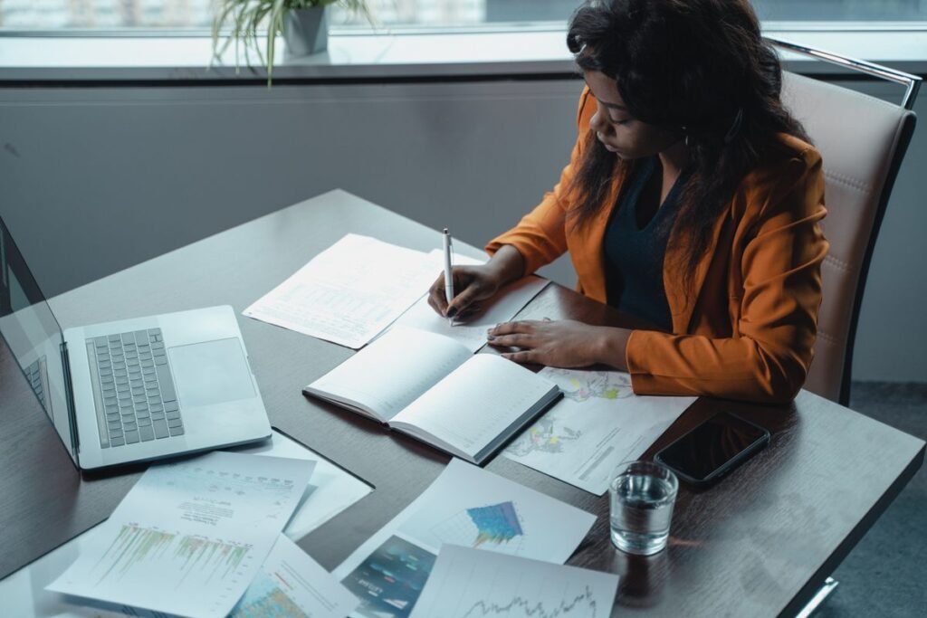 Writing regulatory documents with laptop in an office